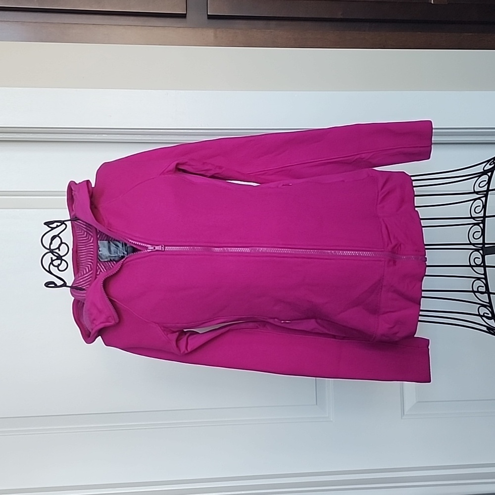 Under Armour, cold gear zip up sweatshirt. Purplish pink in color.